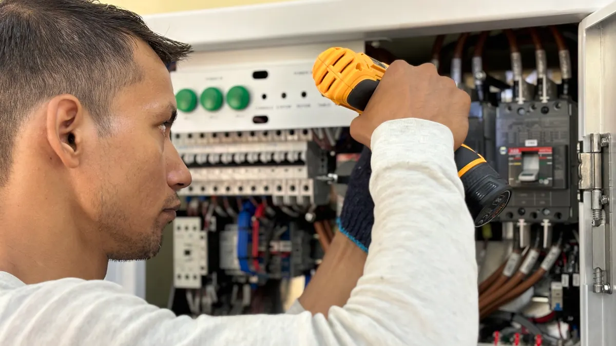 Home electrical safety basics: what every homeowner should know Technician drilling inside an electrical control panel