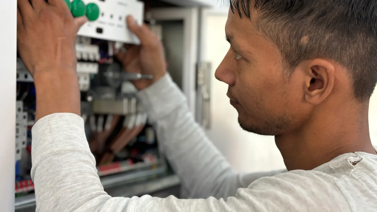 Man inspecting an open electrical panel
