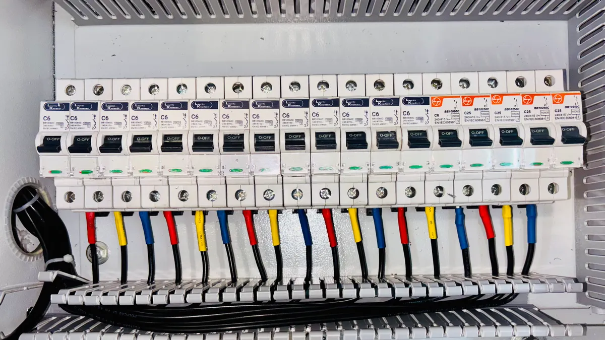 Row of miniature circuit breakers in an electrical panel